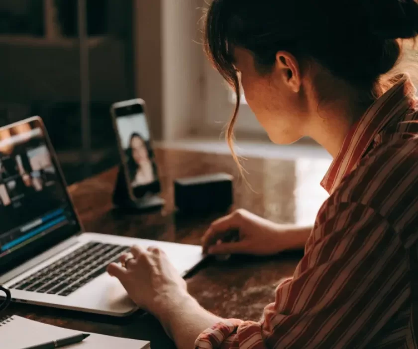 Small business owner using the Gemini Omni video generator to edit a video on a laptop