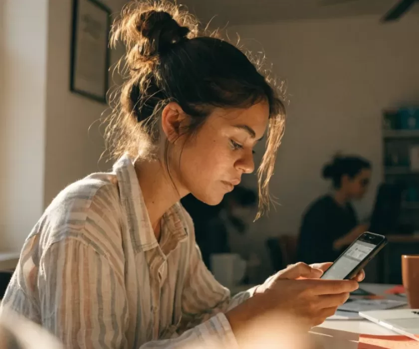 Social media manager reviewing the Instagram algorithm 2026 ranking signals on her phone