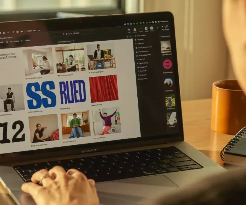 Person reviewing a LinkedIn feed on a laptop, illustrating the new LinkedIn AI slop button