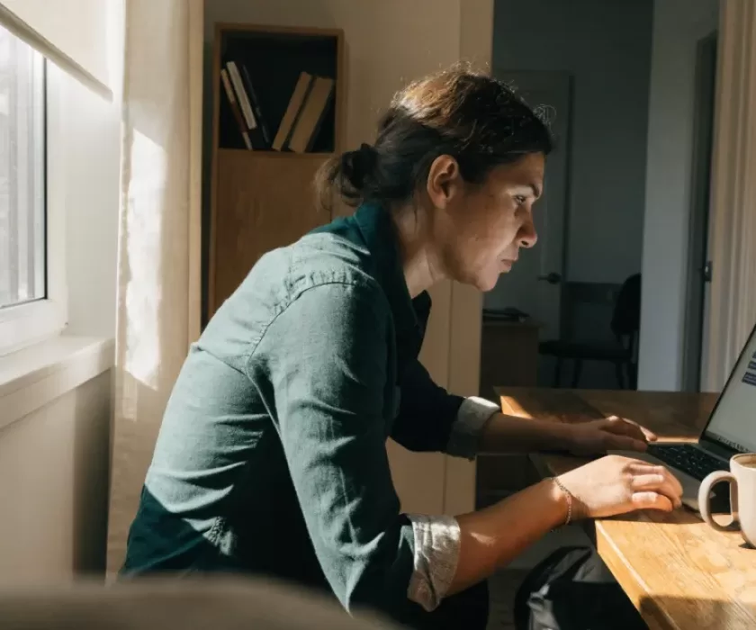 Small business owner reviewing an OpenAI Presence AI customer support chat conversation on a laptop
