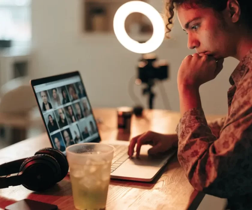 Content creator editing video using YouTube AI creator tools on a laptop